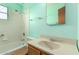 Full bathroom features white tile, bathtub, a single sink and mirror at 4140 E Glenrosa Ave, Phoenix, AZ 85018