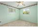 Light green bedroom featuring two windows, neutral carpet and ceiling fan at 4140 E Glenrosa Ave, Phoenix, AZ 85018