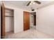 Bedroom with wood door, floral wallpaper border and closet for storage at 4140 E Glenrosa Ave, Phoenix, AZ 85018