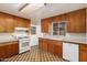 Functional kitchen features wood cabinets, white appliances, and a practical layout for cooking at 4140 E Glenrosa Ave, Phoenix, AZ 85018