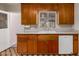 Efficient kitchen featuring wood cabinetry, a bright white sink, and essential appliances at 4140 E Glenrosa Ave, Phoenix, AZ 85018