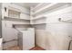 Laundry room featuring white appliances and shelving for ample storage at 4140 E Glenrosa Ave, Phoenix, AZ 85018