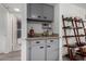 Chic bar area with sleek countertops, stylish shelving, and convenient access to the bathroom at 4150 E Cactus Rd # 205, Phoenix, AZ 85032