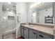 Updated bathroom with a granite vanity, large mirror, and glass shower doors at 4150 E Cactus Rd # 205, Phoenix, AZ 85032