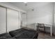 Cozy bedroom with a large closet, desk, and wood-look flooring at 4150 E Cactus Rd # 205, Phoenix, AZ 85032