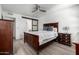 Cozy bedroom with wood-look flooring and barn door to the bathroom at 4150 E Cactus Rd # 205, Phoenix, AZ 85032