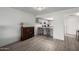 Open dining area with modern floors and bar-style seating, adjacent to the kitchen at 4150 E Cactus Rd # 205, Phoenix, AZ 85032