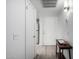 Bright hallway featuring clean white walls, modern flooring, and convenient closet space at 4150 E Cactus Rd # 205, Phoenix, AZ 85032