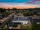 Aerial view featuring a property with a well-manicured backyard, a golf course, and scenic mountain views at 4252 E Zia St, Phoenix, AZ 85044