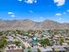 Aerial view of a residential neighborhood in the mountains with lush greenery and blue skies at 4252 E Zia St, Phoenix, AZ 85044