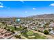 Bird's-eye view of a neighborhood next to a golf course with mountain views on a sunny day at 4252 E Zia St, Phoenix, AZ 85044