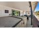 Covered back patio with a hot tub, string lights, and outdoor dining area, perfect for year-round enjoyment at 4252 E Zia St, Phoenix, AZ 85044