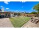 Wide backyard features a lush lawn, mature trees, and ample space for outdoor activities and entertaining at 4252 E Zia St, Phoenix, AZ 85044