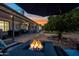 Backyard fire pit with ample seating, perfect for cozy evenings outdoors under string lights at 4252 E Zia St, Phoenix, AZ 85044