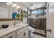 Modern bathroom featuring a walk-in shower with glass door and a stylish marble vanity at 4252 E Zia St, Phoenix, AZ 85044