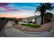 Attractive single-story home with desert landscaping, lush lawn, and sunset sky at 4252 E Zia St, Phoenix, AZ 85044