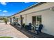 Inviting front porch featuring a seating area and well-maintained desert landscaping, with white brick and blue trim at 4252 E Zia St, Phoenix, AZ 85044