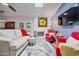 Bright and cozy living room showcases a fireplace, stylish decor, and French doors to the outdoors at 4252 E Zia St, Phoenix, AZ 85044