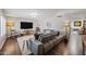 A living room featuring a modern gray couch on a white rug and hardwood floors at 4252 E Zia St, Phoenix, AZ 85044