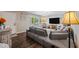 An elegant living room features hardwood floors, large windows, and a modern gray sectional couch at 4252 E Zia St, Phoenix, AZ 85044