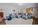 Cozy living room features hardwood floors, a large white rug, and a modern sectional couch at 4252 E Zia St, Phoenix, AZ 85044