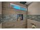 Custom shower with rainfall showerhead, built-in niche, and sleek tile design at 4252 E Zia St, Phoenix, AZ 85044