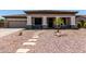 Charming single-story home with a desert landscape, stone pathway, and a welcoming covered porch at 465 E Frances Ln, Gilbert, AZ 85295
