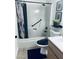 Bright bathroom featuring a shower with grab bar, and black fixtures at 4814 W Rose Ln, Glendale, AZ 85301