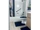 Well-maintained bathroom features a shower with black fixtures and a decorative shower curtain at 4814 W Rose Ln, Glendale, AZ 85301