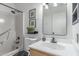 Cozy bathroom featuring a shower-tub combo and a stylish vanity with decor at 4814 W Rose Ln, Glendale, AZ 85301