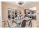 Cozy dining area featuring a modern light fixture and a glass dining table at 4814 W Rose Ln, Glendale, AZ 85301