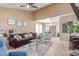Open living room features vaulted ceilings, modern fan, and is adjacent to the dining area at 4814 W Rose Ln, Glendale, AZ 85301