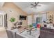 Open living area featuring ceiling fan, large windows, and comfortable seating at 4814 W Rose Ln, Glendale, AZ 85301