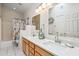 Bathroom features dual sinks, modern lighting, and a shower with nautical themed shower curtain at 4918 W Wahalla Ln, Glendale, AZ 85308