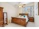 Cozy bedroom with wooden furniture, ceiling fan, and a view of the outside at 4918 W Wahalla Ln, Glendale, AZ 85308
