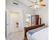 Bedroom with view of the bathroom includes a wooden wardrobe and ceiling fan at 4918 W Wahalla Ln, Glendale, AZ 85308