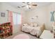 Adorable bedroom featuring a ceiling fan and a cozy bed at 4918 W Wahalla Ln, Glendale, AZ 85308