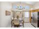 Dining area has a window view, stainless fridge, and a decorative wooden wall hanging at 4918 W Wahalla Ln, Glendale, AZ 85308