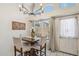 Bright dining room features a modern chandelier, a wooden table, and four upholstered chairs at 4918 W Wahalla Ln, Glendale, AZ 85308