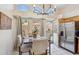 Bright dining area features patio access, stainless steel refrigerator, and seating for four at 4918 W Wahalla Ln, Glendale, AZ 85308