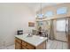 Open concept dining area has a modern light fixture and sliding doors to the outdoor at 4918 W Wahalla Ln, Glendale, AZ 85308