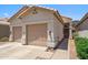 This home's exterior is nicely maintained, with a two-car garage and beautiful desert-style landscaping at 4918 W Wahalla Ln, Glendale, AZ 85308