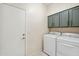 Laundry room featuring a washer, dryer, and upper cabinets at 4918 W Wahalla Ln, Glendale, AZ 85308