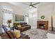 This cozy living area includes a warm fireplace, soft rug, leather seating and vaulted ceilings at 4918 W Wahalla Ln, Glendale, AZ 85308