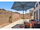 Back patio featuring an outdoor umbrella and landscaping at 4918 W Wahalla Ln, Glendale, AZ 85308