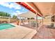 Spacious backyard with pool, patio, pergola, seating and desert landscaping at 5140 N 69Th Ave, Glendale, AZ 85303