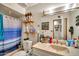Cozy bathroom featuring a shower with blue curtain, decor and vintage vanity sink at 5140 N 69Th Ave, Glendale, AZ 85303