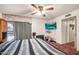 Bedroom with a large bed, ceiling fan, television, and access to a private balcony at 5140 N 69Th Ave, Glendale, AZ 85303