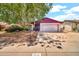 Traditional home featuring a two-car garage and mature landscaping in a suburban neighborhood at 5140 N 69Th Ave, Glendale, AZ 85303