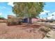 Suburban house with mature landscaping and large shade tree in the front yard at 5140 N 69Th Ave, Glendale, AZ 85303